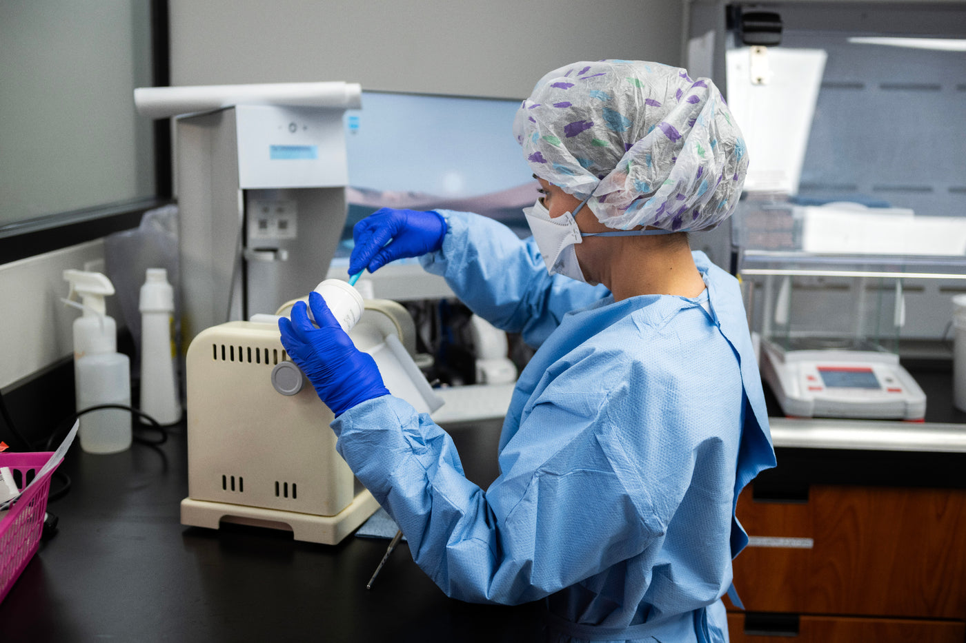 A Magnolia Pharmacy pharmacist preparing a compounded prescription by hand