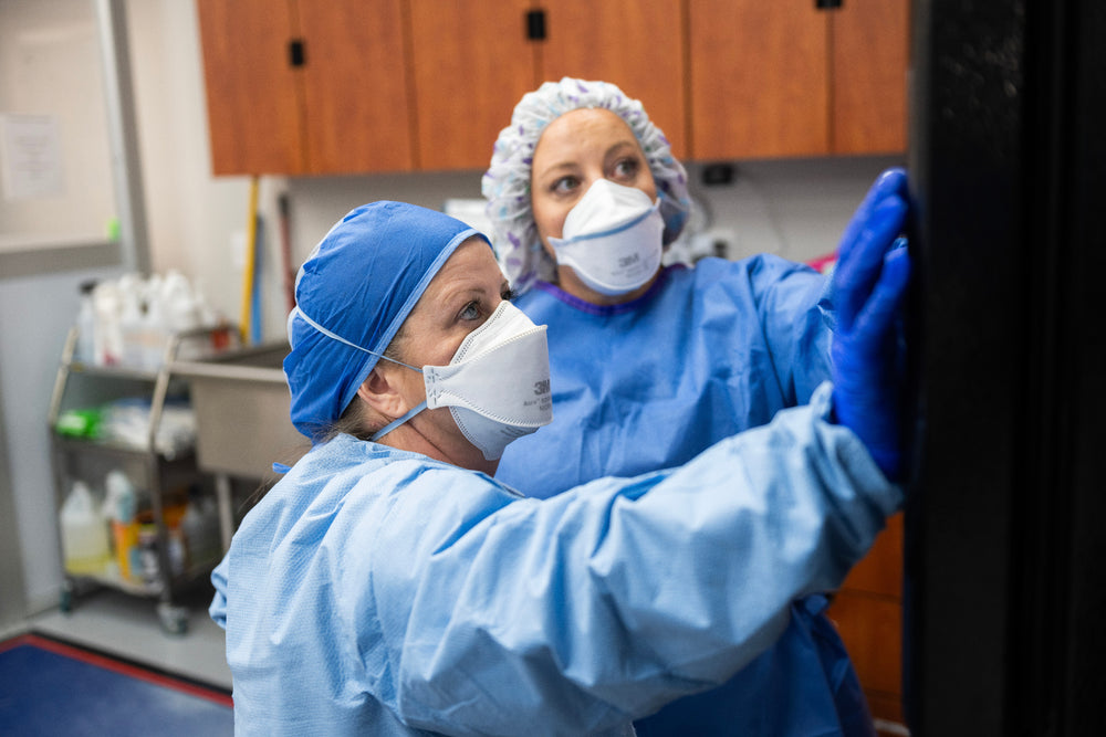 Pharmacy technicians in sterile scrubs compounding thyroid medication in the Magnolia Pharmacy cleanroom